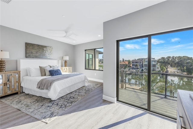 bedroom with a ceiling fan, access to outside, wood finished floors, and baseboards