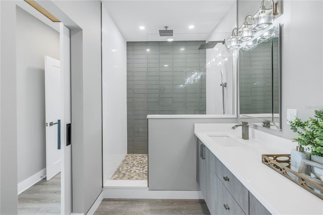 full bathroom featuring visible vents, walk in shower, wood finished floors, and vanity