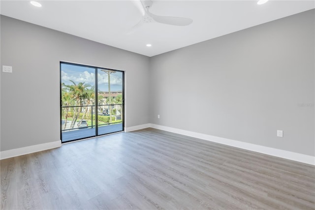 empty room featuring recessed lighting, wood finished floors, baseboards, and ceiling fan