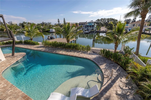 outdoor pool with a patio and a water view