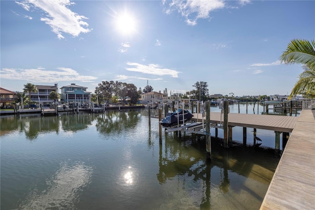 view of dock with boat lift and a water view