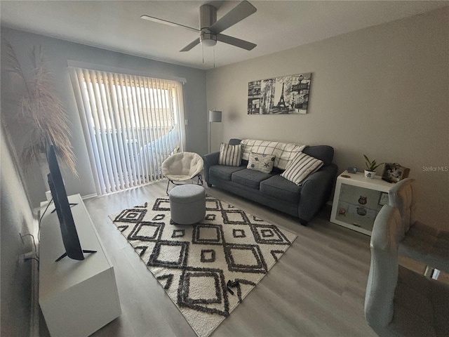 living room with wood finished floors and ceiling fan