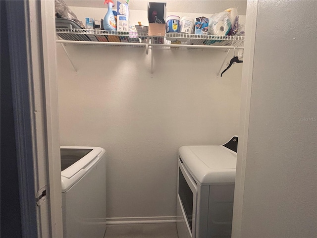 laundry area with washer and dryer, laundry area, and baseboards