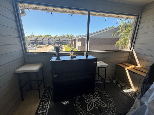 sunroom / solarium featuring a residential view