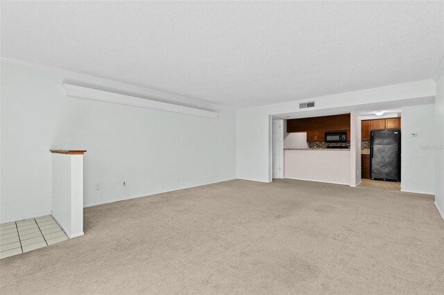 unfurnished living room with visible vents, light colored carpet, ornamental molding, and light tile patterned flooring