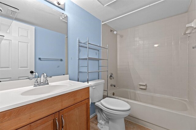 bathroom featuring vanity, tile patterned floors, toilet, and shower / bathing tub combination