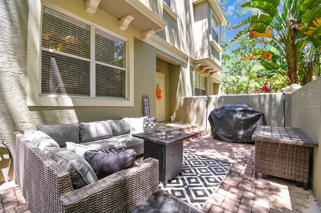 view of patio featuring outdoor lounge area, fence, and grilling area