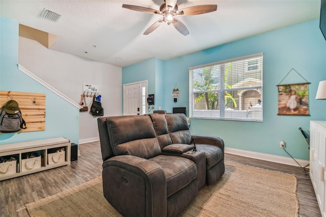 sitting room featuring visible vents, baseboards, wood finished floors, and a ceiling fan