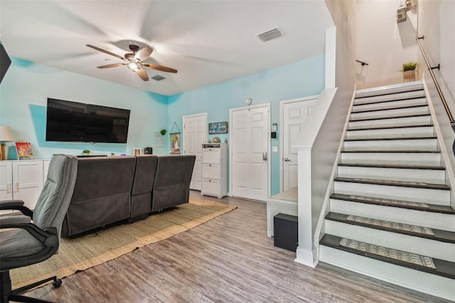 home office with wood finished floors, visible vents, and ceiling fan