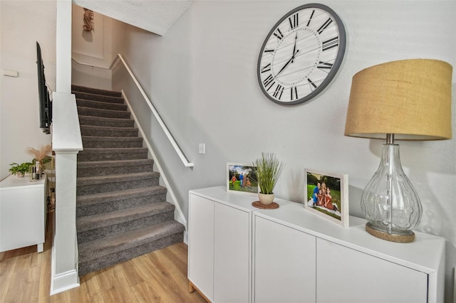 stairway with wood finished floors