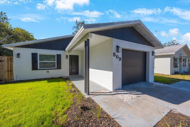 ranch-style home featuring a garage, concrete driveway, and a front yard