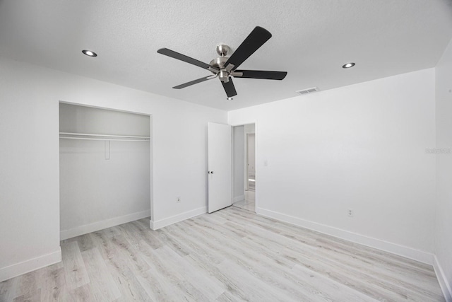 unfurnished bedroom featuring light wood-style floors, visible vents, and baseboards