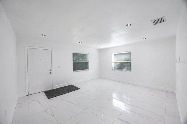 spare room featuring recessed lighting, baseboards, visible vents, and marble finish floor