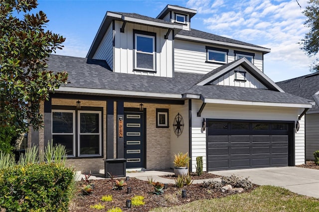 view of front of house with board and batten siding, concrete driveway, an attached garage, and a shingled roof