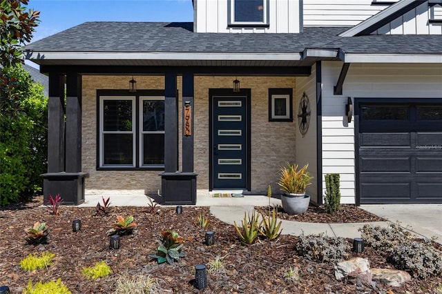 property entrance featuring covered porch and a shingled roof