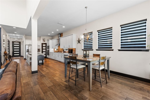 dining area with dark wood finished floors, a notable chandelier, recessed lighting, and baseboards