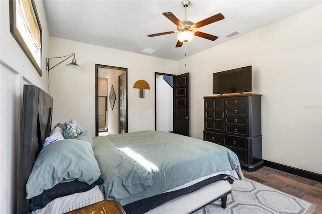 bedroom featuring visible vents, wood finished floors, connected bathroom, baseboards, and ceiling fan