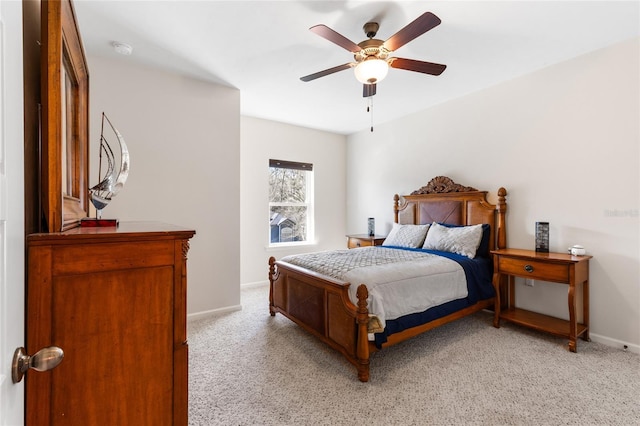 bedroom with ceiling fan, baseboards, and light carpet