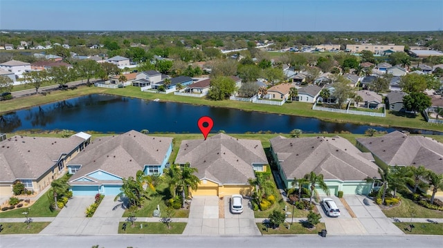 birds eye view of property featuring a residential view and a water view