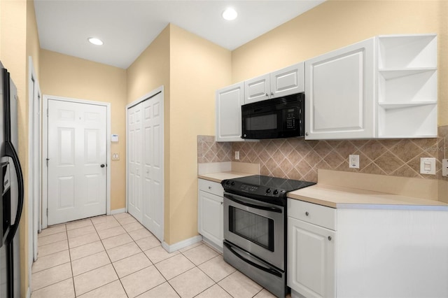 kitchen featuring tasteful backsplash, light tile patterned floors, white cabinets, black appliances, and open shelves