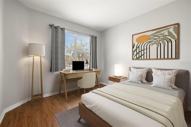 bedroom featuring baseboards and wood finished floors