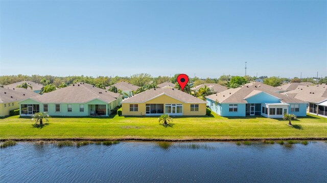 drone / aerial view featuring a residential view and a water view