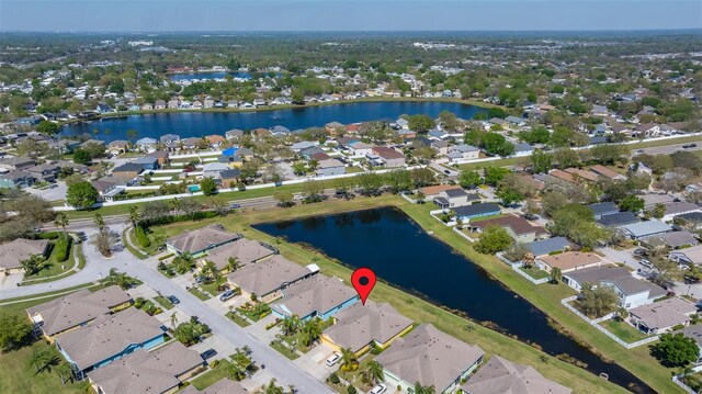 birds eye view of property with a residential view and a water view