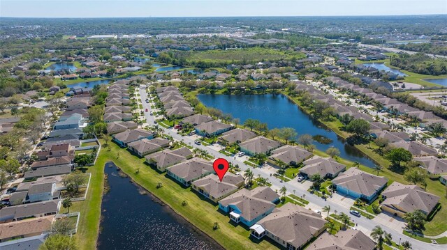 drone / aerial view featuring a residential view and a water view