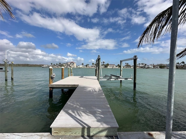 dock area with a water view and boat lift