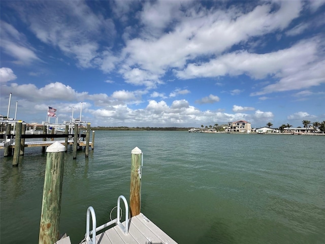 dock area with boat lift and a water view