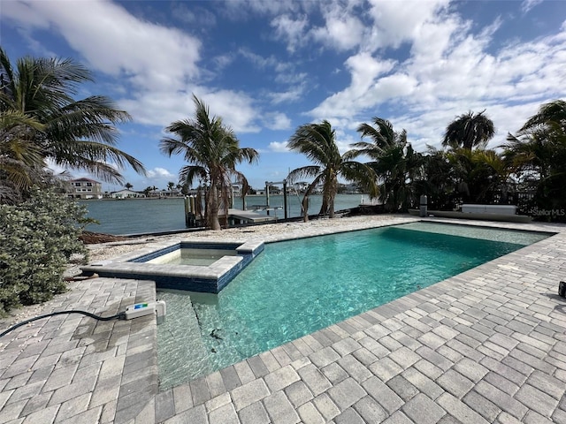 view of pool with a patio and a pool with connected hot tub