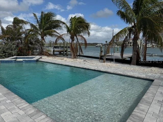 view of swimming pool with a pool with connected hot tub