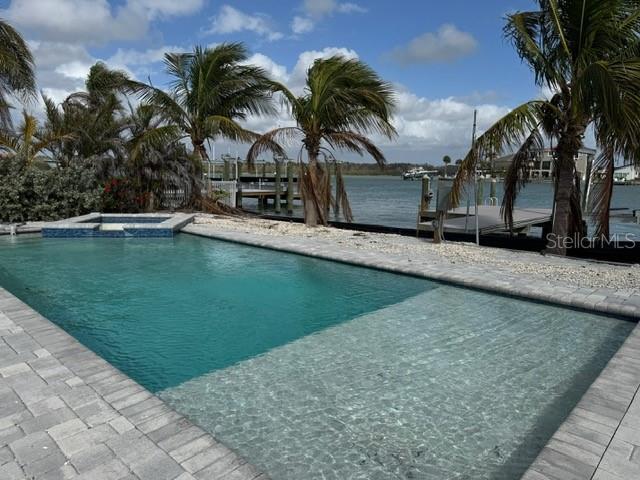 pool featuring an in ground hot tub and a boat dock