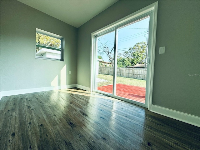 spare room featuring wood finished floors and baseboards