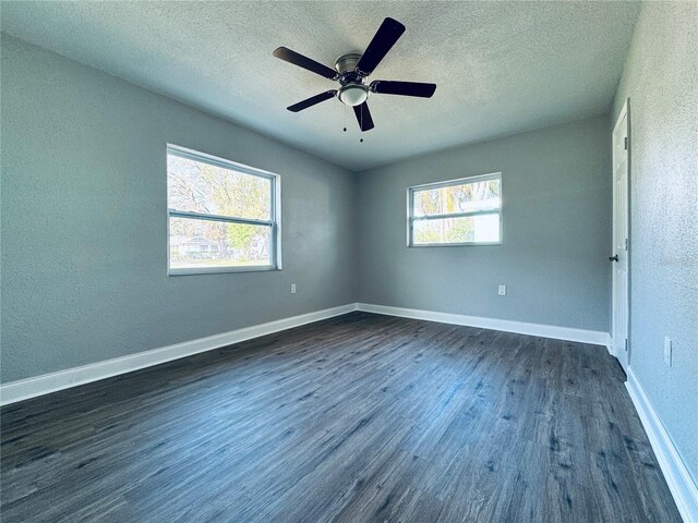 1409 Franklin St, Clearwater, FL 33756 - unfurnished bedroom with dark wood-type flooring, baseboards, and a textured ceiling