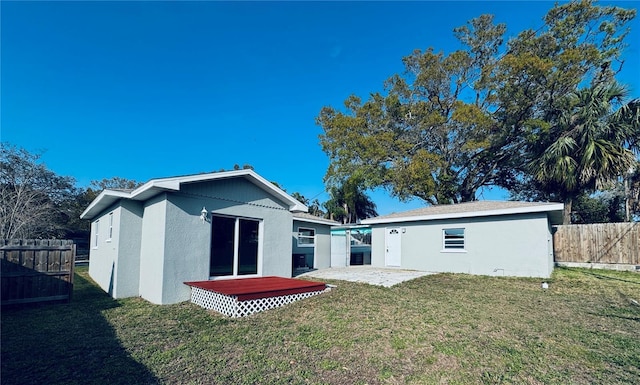 1409 Franklin St, Clearwater, FL 33756 - back of property with a yard, an outdoor structure, stucco siding, and fence