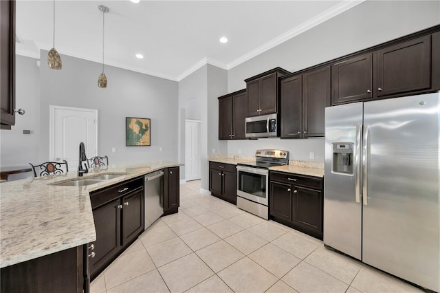 kitchen featuring dark brown cabinets, stainless steel appliances, crown molding, and a sink