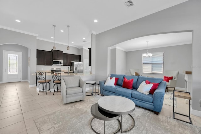 living area featuring arched walkways, visible vents, a chandelier, and light tile patterned floors