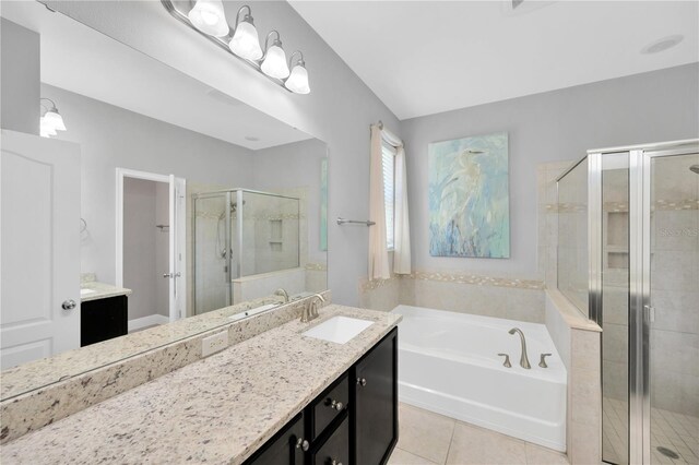 full bath featuring vanity, a shower stall, a bath, and tile patterned floors