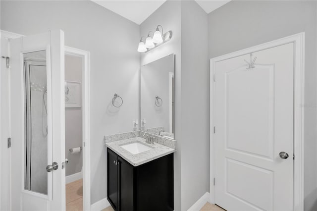 full bathroom with tile patterned floors, vanity, and baseboards