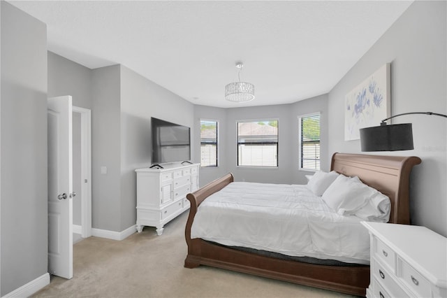 bedroom featuring baseboards and light carpet