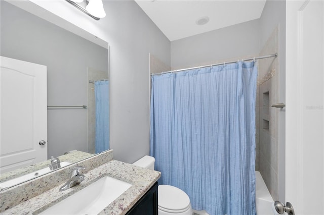 bathroom with shower / bath combination with curtain, toilet, and vanity