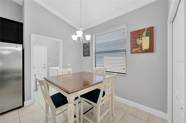 dining area with light tile patterned floors, an inviting chandelier, baseboards, and lofted ceiling