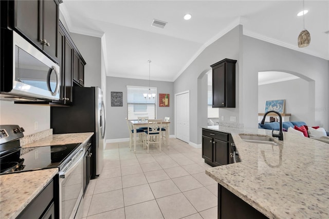 kitchen with visible vents, crown molding, appliances with stainless steel finishes, arched walkways, and a sink