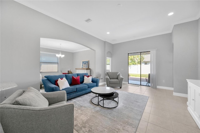 living room featuring visible vents, arched walkways, crown molding, light tile patterned floors, and baseboards