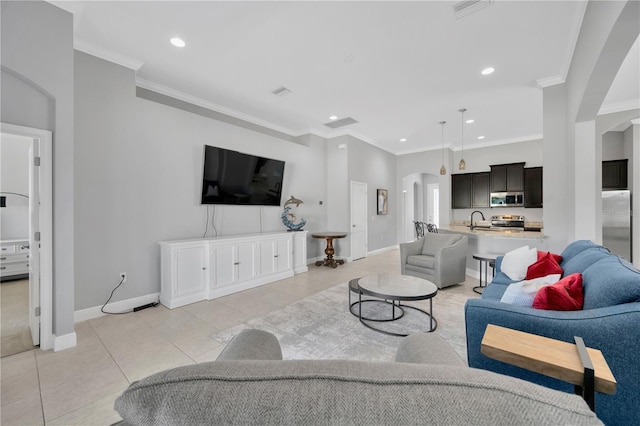 living room with light tile patterned floors, arched walkways, recessed lighting, and crown molding