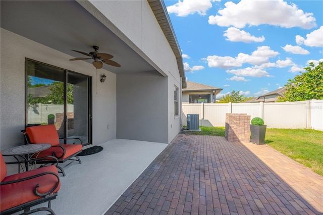 view of patio with central AC unit, fence, and ceiling fan