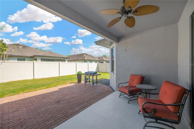 view of patio / terrace with a fenced backyard and a ceiling fan