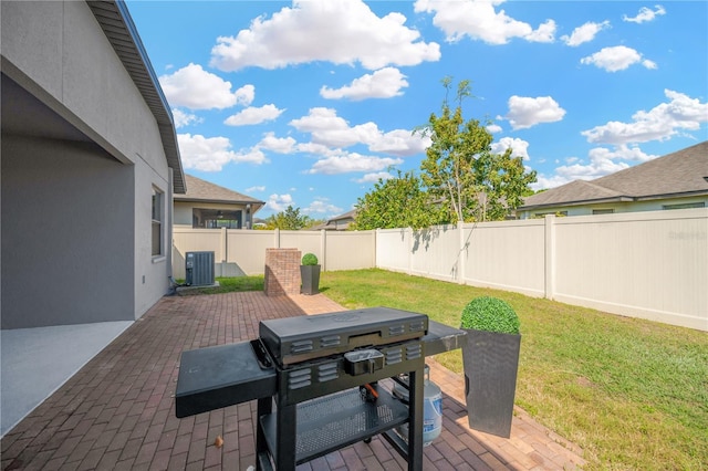 view of patio / terrace featuring grilling area, central AC, and a fenced backyard