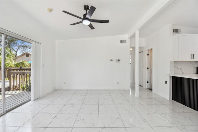unfurnished living room featuring a ceiling fan, visible vents, and marble finish floor